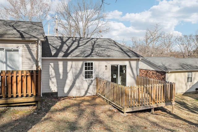 back of house with a lawn and a deck