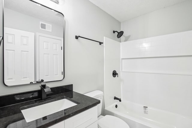 full bathroom featuring vanity, tub / shower combination, a textured ceiling, and toilet