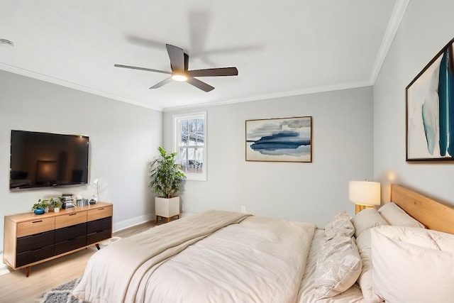 bedroom featuring ornamental molding, light wood-type flooring, and ceiling fan