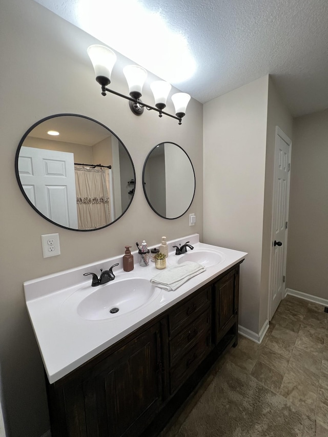 bathroom with vanity and a textured ceiling