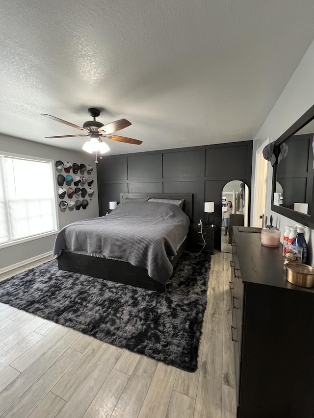 bedroom with a textured ceiling and ceiling fan