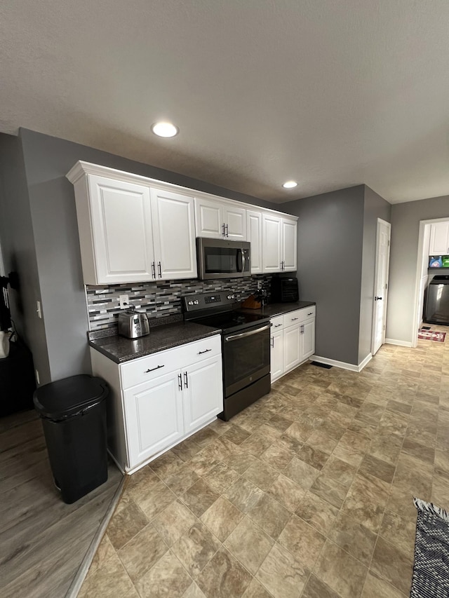 kitchen with white cabinetry, electric range, and decorative backsplash