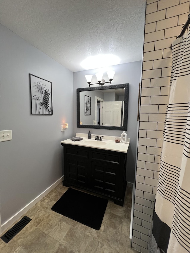 bathroom featuring vanity, a chandelier, a shower with shower curtain, and a textured ceiling