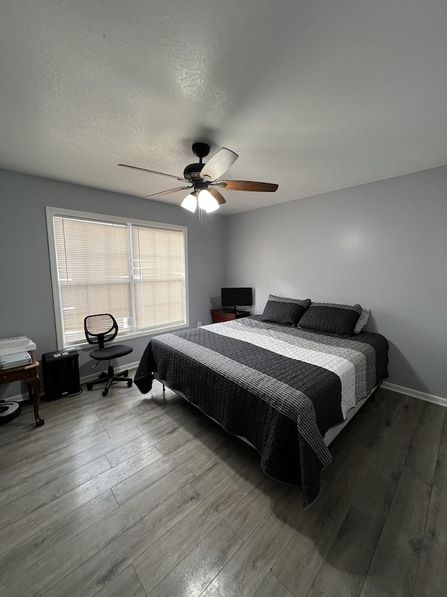 bedroom featuring wood-type flooring and ceiling fan