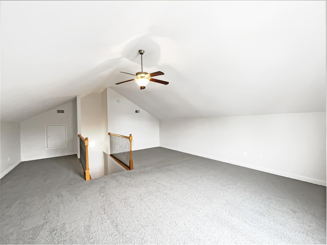 additional living space with vaulted ceiling and dark colored carpet