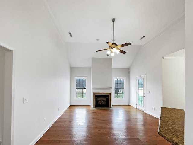 unfurnished living room featuring ceiling fan, lofted ceiling, ornamental molding, and dark hardwood / wood-style flooring