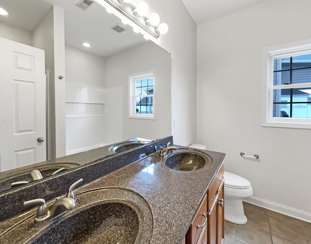 bathroom with vanity, toilet, and tile patterned flooring