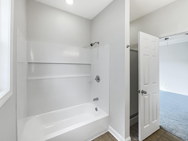 bathroom featuring tile patterned flooring and washtub / shower combination