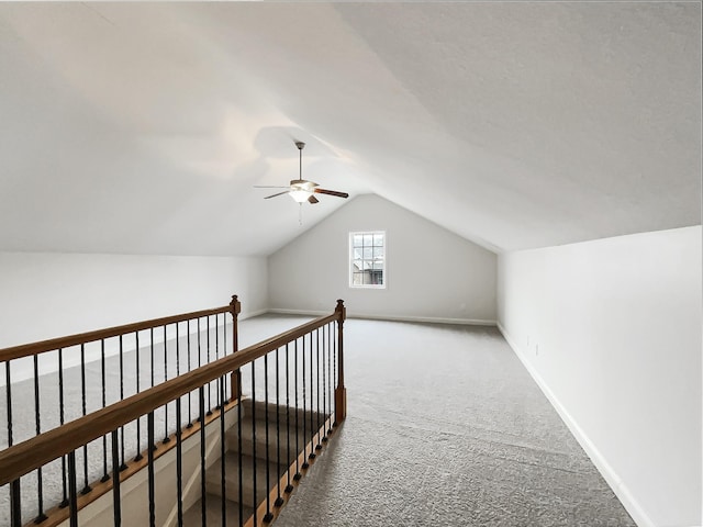 additional living space featuring lofted ceiling, carpet floors, and ceiling fan