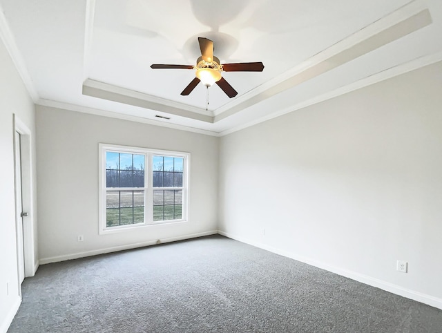 unfurnished room featuring ornamental molding, a raised ceiling, ceiling fan, and carpet