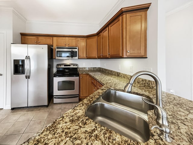 kitchen with dark stone countertops, sink, crown molding, and stainless steel appliances