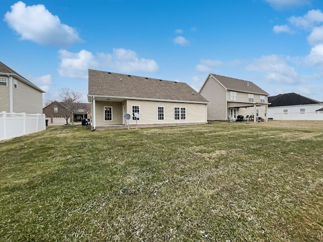 back of house with a yard and a patio