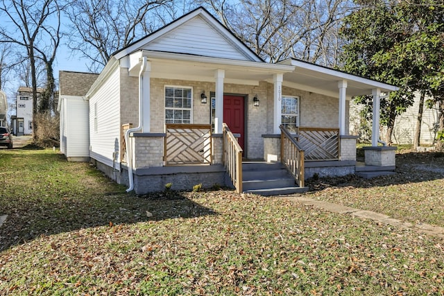 bungalow featuring a porch and a front lawn