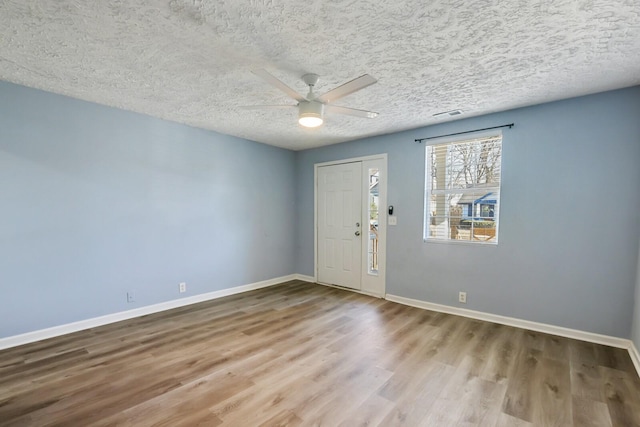 foyer with wood-type flooring, ceiling fan, and a textured ceiling