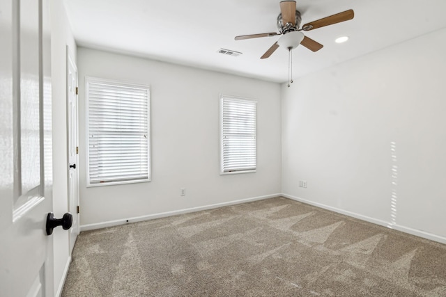 carpeted empty room featuring ceiling fan