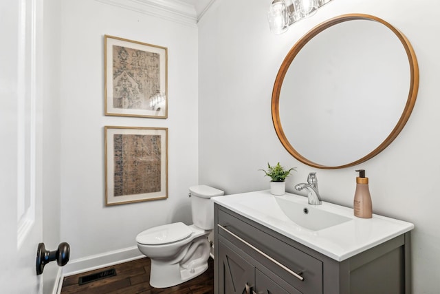 bathroom featuring crown molding, vanity, toilet, and hardwood / wood-style floors