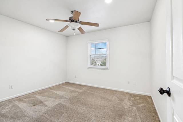 carpeted spare room with ceiling fan