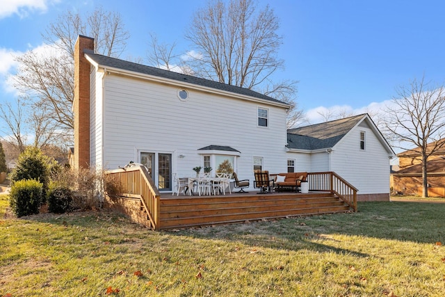 back of house with a lawn and a deck