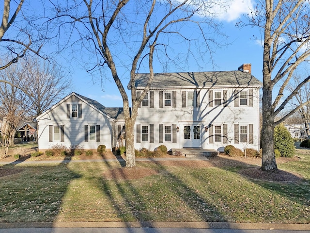 colonial home with a front lawn