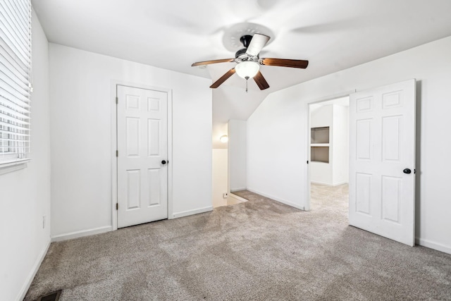 bonus room with ceiling fan, vaulted ceiling, and light carpet