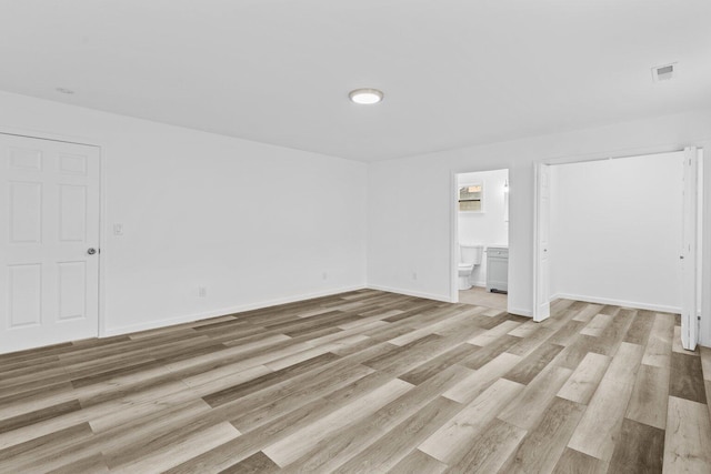 empty room with light hardwood / wood-style flooring