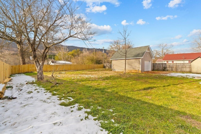 yard layered in snow with an outbuilding