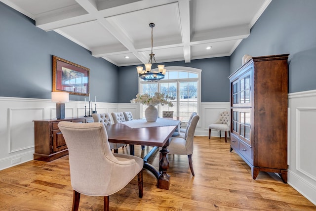 dining area featuring beamed ceiling, coffered ceiling, light hardwood / wood-style flooring, and a notable chandelier