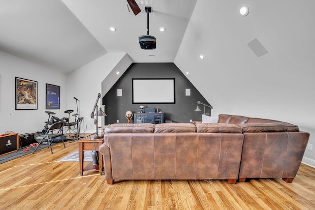 home theater with lofted ceiling and light wood-type flooring