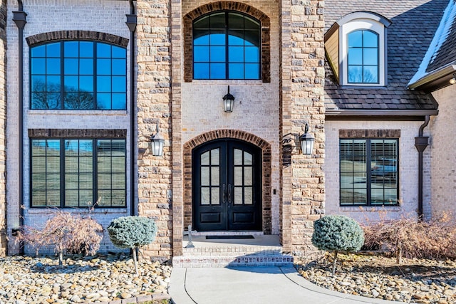 view of exterior entry featuring french doors