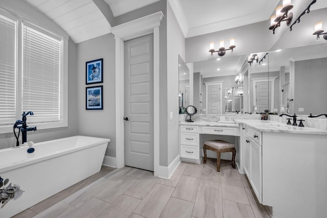 bathroom with vanity, crown molding, and a tub to relax in