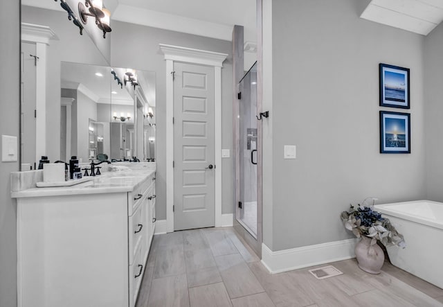 bathroom featuring vanity, ornamental molding, and plus walk in shower