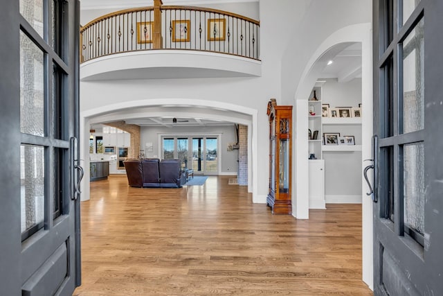 entrance foyer with light hardwood / wood-style floors and a high ceiling