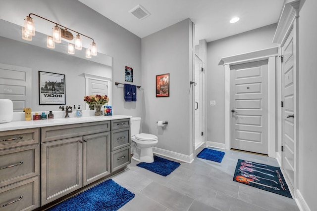 bathroom with tile patterned flooring, vanity, toilet, and walk in shower