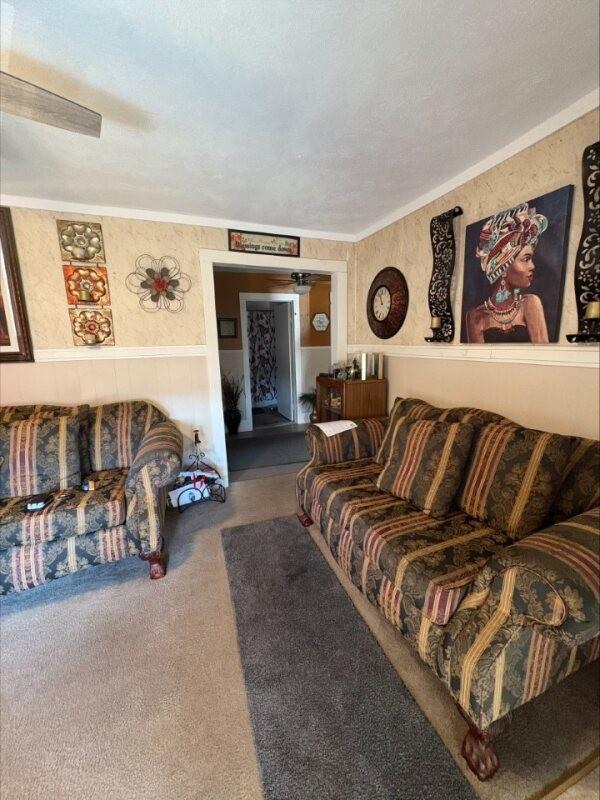 carpeted living room featuring ornamental molding