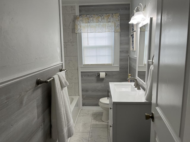 full bathroom featuring vanity, washtub / shower combination, and toilet