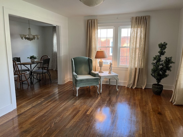 living area featuring dark hardwood / wood-style floors and a chandelier