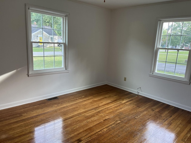 unfurnished room with crown molding and dark hardwood / wood-style flooring