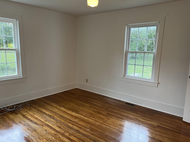 spare room featuring dark hardwood / wood-style flooring