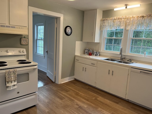 kitchen featuring a healthy amount of sunlight, sink, white appliances, and white cabinets