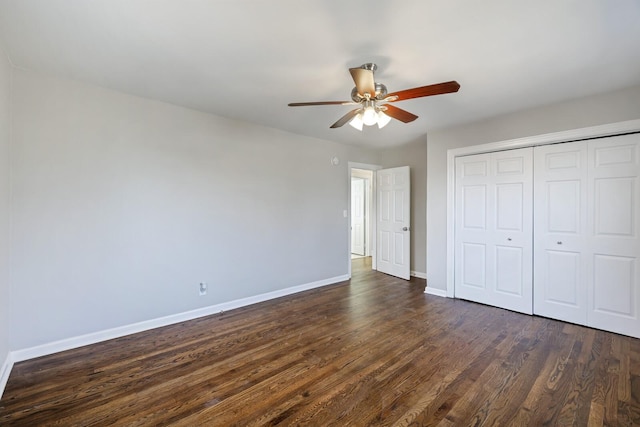 unfurnished bedroom with ceiling fan, dark hardwood / wood-style flooring, and a closet