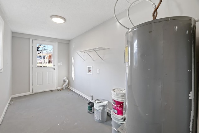 clothes washing area featuring washer hookup, electric water heater, and a textured ceiling