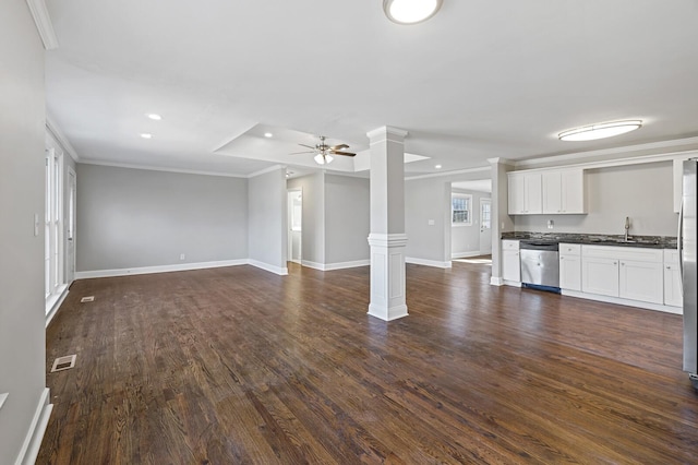 unfurnished living room with crown molding, ceiling fan, dark hardwood / wood-style floors, and ornate columns