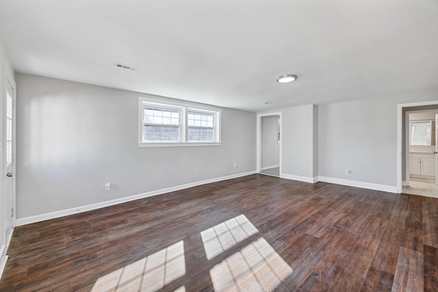 unfurnished room with dark hardwood / wood-style flooring