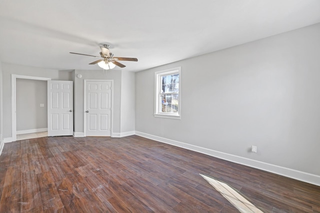 unfurnished room with dark hardwood / wood-style flooring and ceiling fan