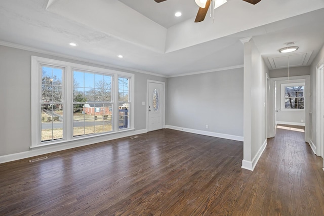 spare room with ornamental molding, dark wood-type flooring, ceiling fan, and a tray ceiling