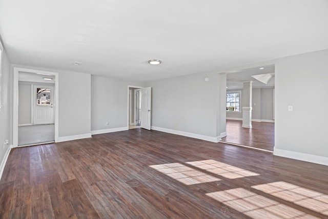 unfurnished room with dark hardwood / wood-style flooring