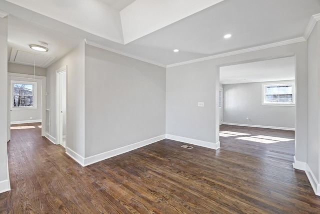 empty room with ornamental molding, plenty of natural light, and dark hardwood / wood-style flooring