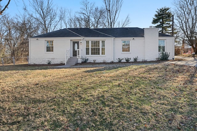 ranch-style home with a front lawn