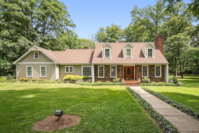 cape cod home featuring a front yard