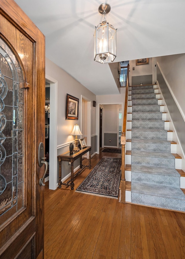 foyer featuring hardwood / wood-style flooring and a notable chandelier